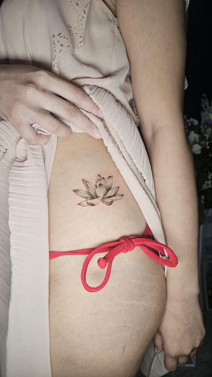 Intricate fine line tattoo — black and gray botanical composition